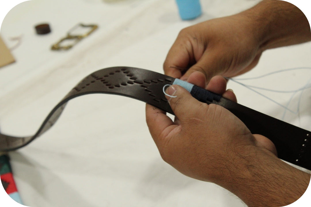 hand-stitching a belt