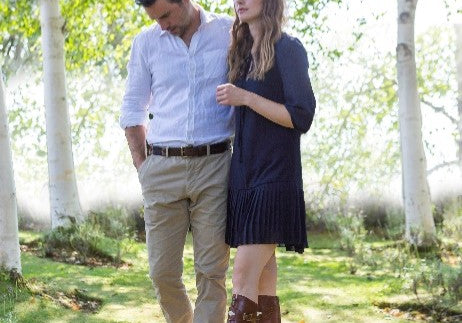 two people walking in the trees